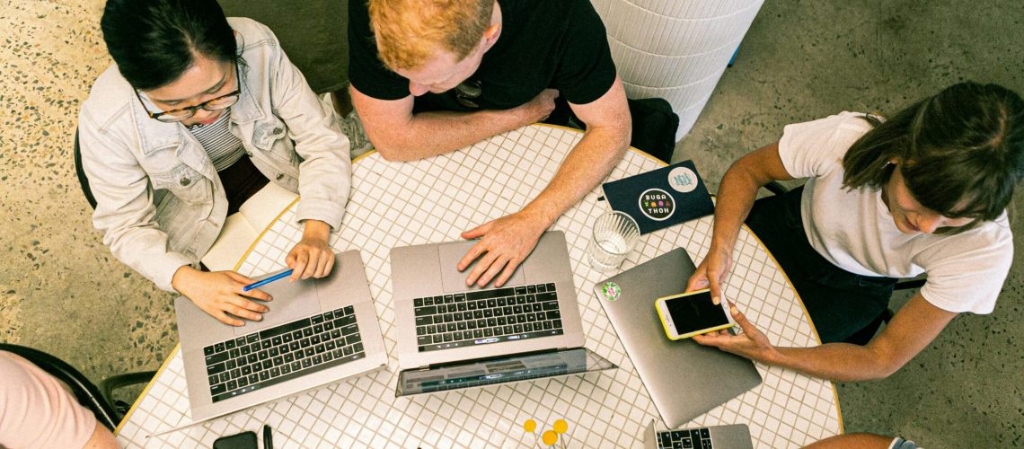 Top view of diverse team collaboratively working in a modern office setting.